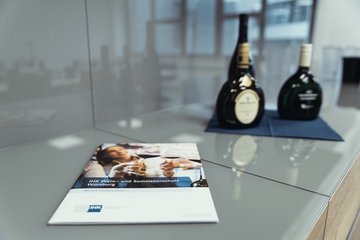 3 Bocksbeitel und Broschüre liegen auf dem Tisch
